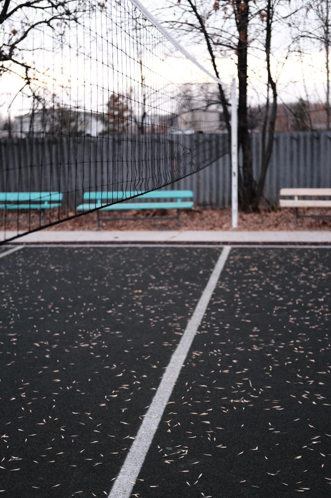 Tennis court with blue benches